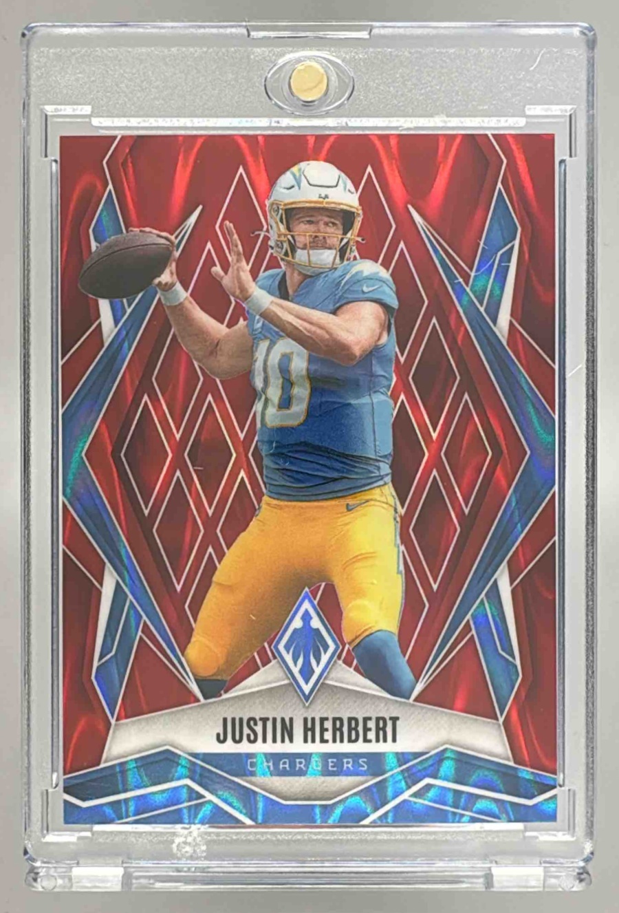 Card image for 2025 Panini Football Phoenix Justin Herbert Red /99 #58 Los Angeles Chargers