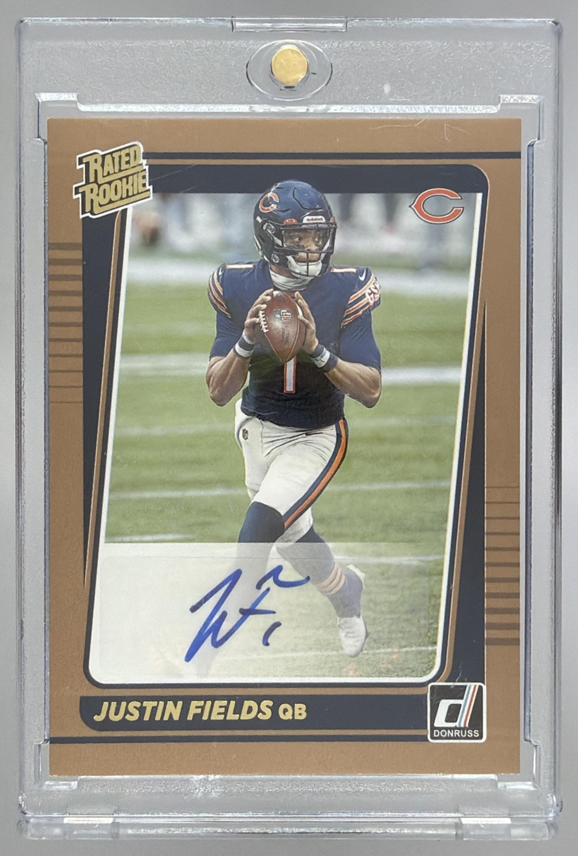Card image for 2021 Panini Donruss Justin Fields Rated Rookie Auto Bronze #253 RC Bears