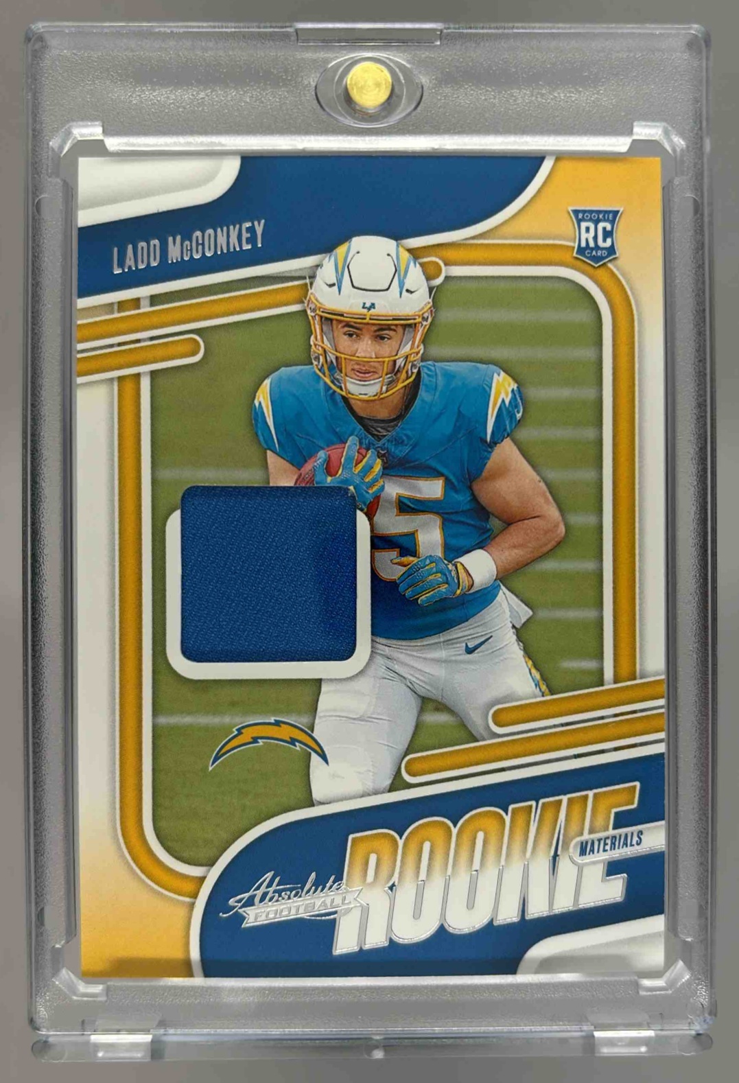 Card image for 2024 Panini Absolute Ladd McConkey Rookie Materials #ARM-LMY RC MEM Chargers