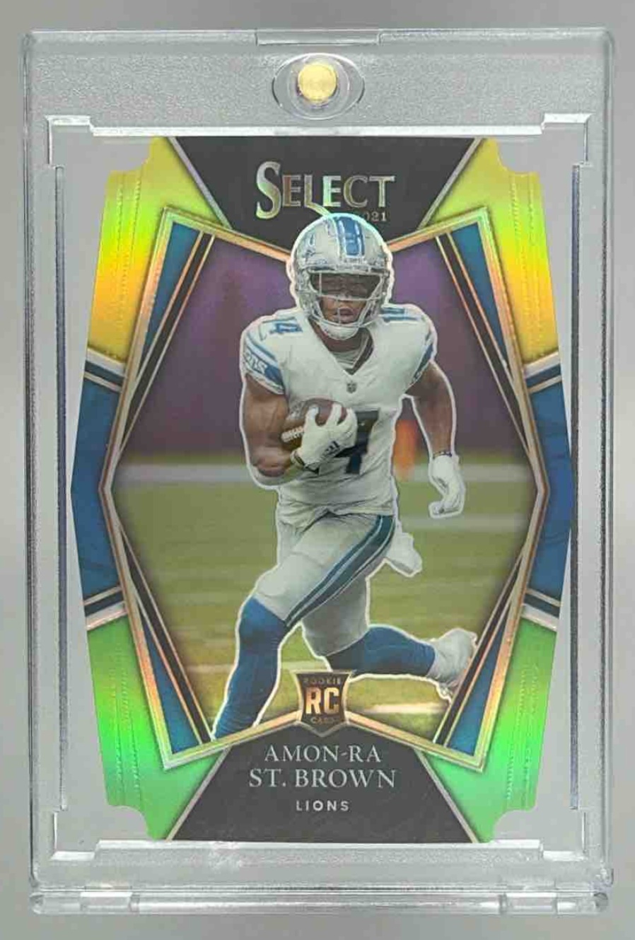 Card image for 2021 Panini Select Amon-Ra St. Brown Black and Gold Prizm Die Cut #173 RC Premier Level Lions