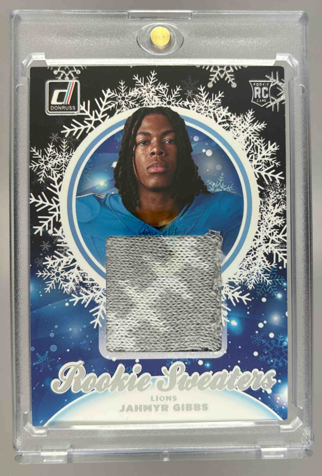 Card image for 2023 Panini Donruss Jahmyr Gibbs Rookie Holiday Sweater Relics #HS-JGI RC MEM Lions