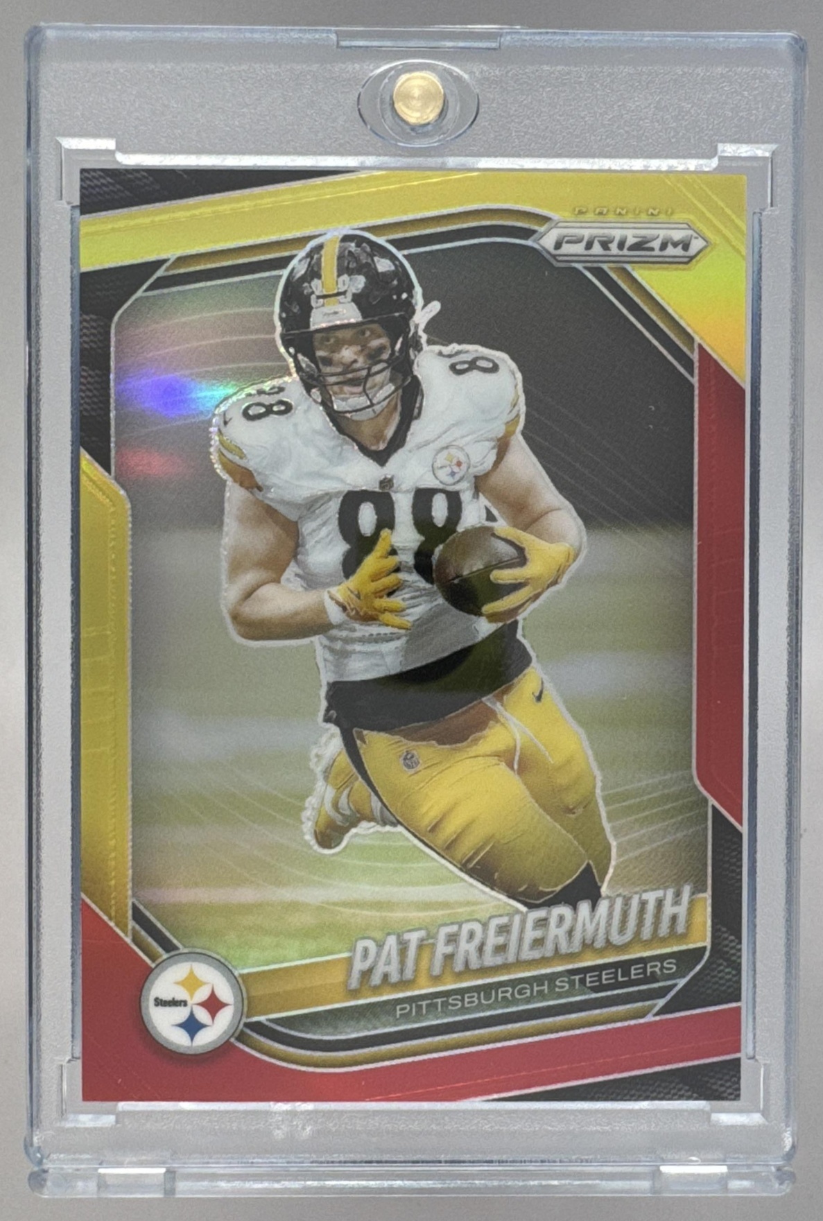 Card image for 2025 Panini Prizm Pat Freiermuth Red & Yellow /44 #243 Steelers