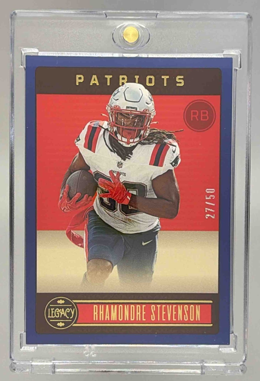 Card image for 2023 Panini Legacy Rhamondre Stevenson Premium Edition Ruby Mini /50 #68 Patriots