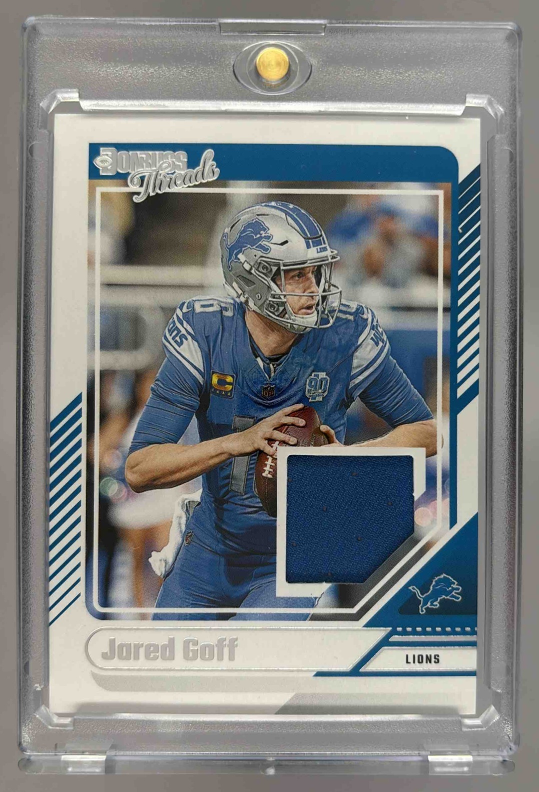 Card image for 2024 Panini Football Donruss Jared Goff Threads #DTH-JGO MEM Detroit Lions
