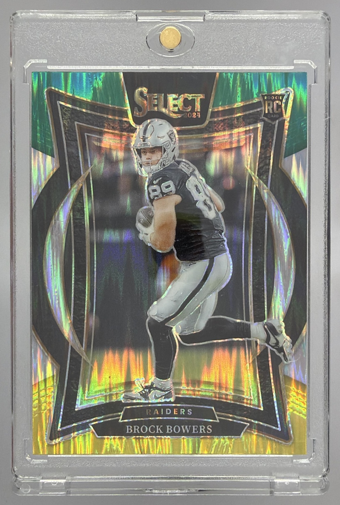 Card image for 2024 Panini Select Brock Bowers Concourse Black and Green Prizm Shock #31 RC Raiders