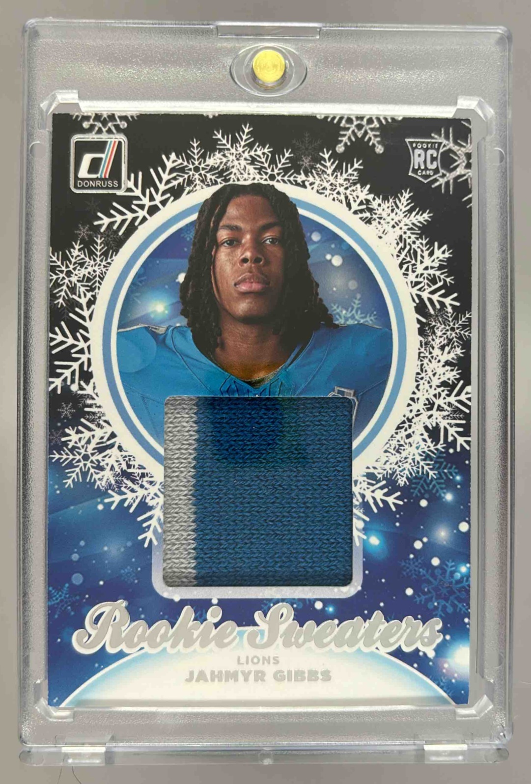 Card image for 2023 Panini Donruss Jahmyr Gibbs Rookie Holiday Sweater Relics #HS-JGI RC MEM Lions