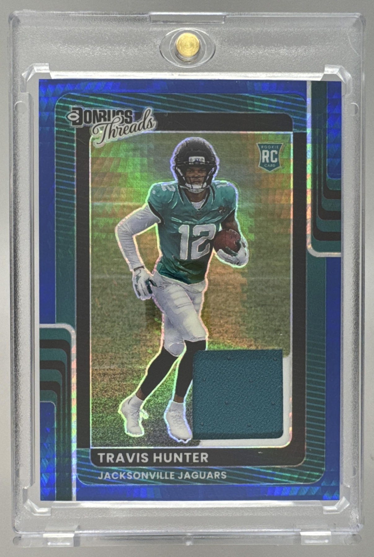Card image for 2025 Panini Donruss Optic Travis Hunter Threads Blue Hyper Prizm #DTBH-THR MEM RC Jaguars