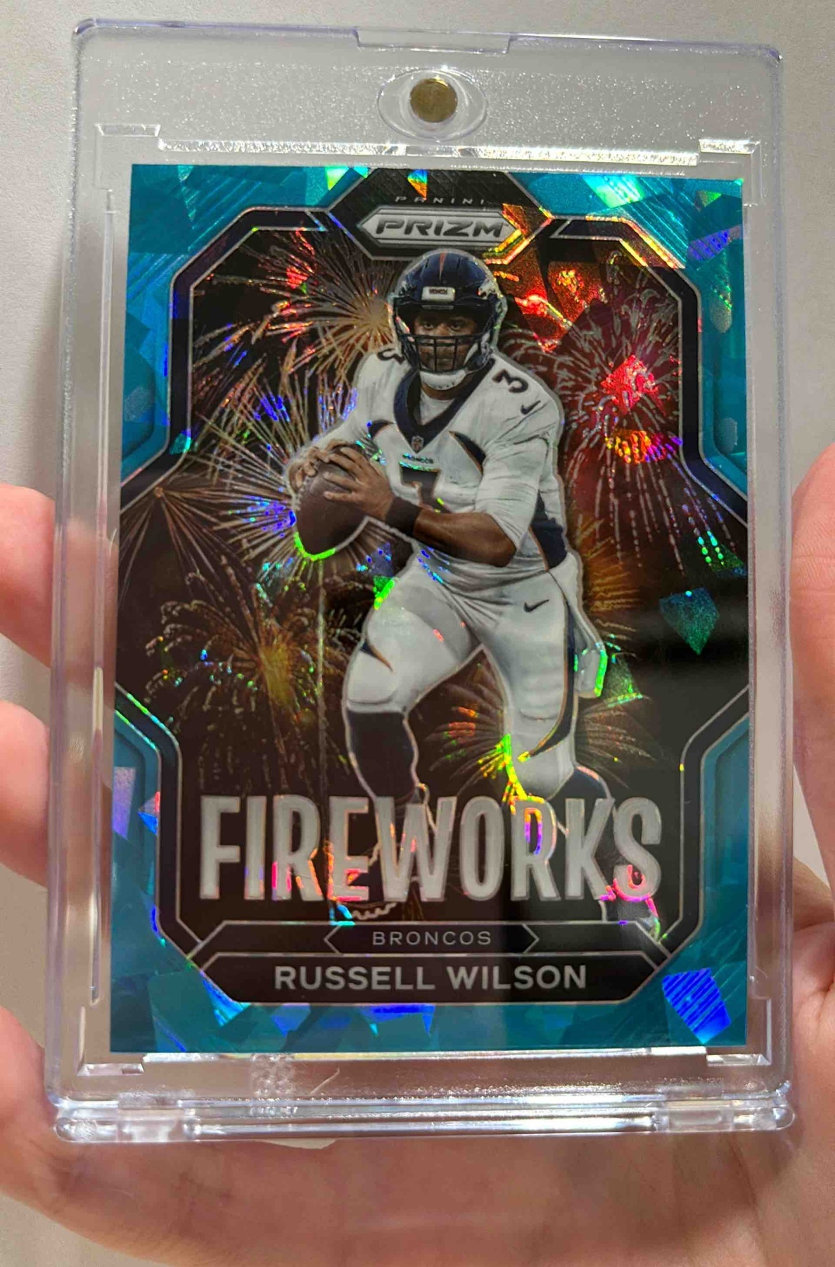 Card image for 2022 Panini Prizm Russell Wilson Fireworks Prizms Blue Ice /99 #F-5 Broncos