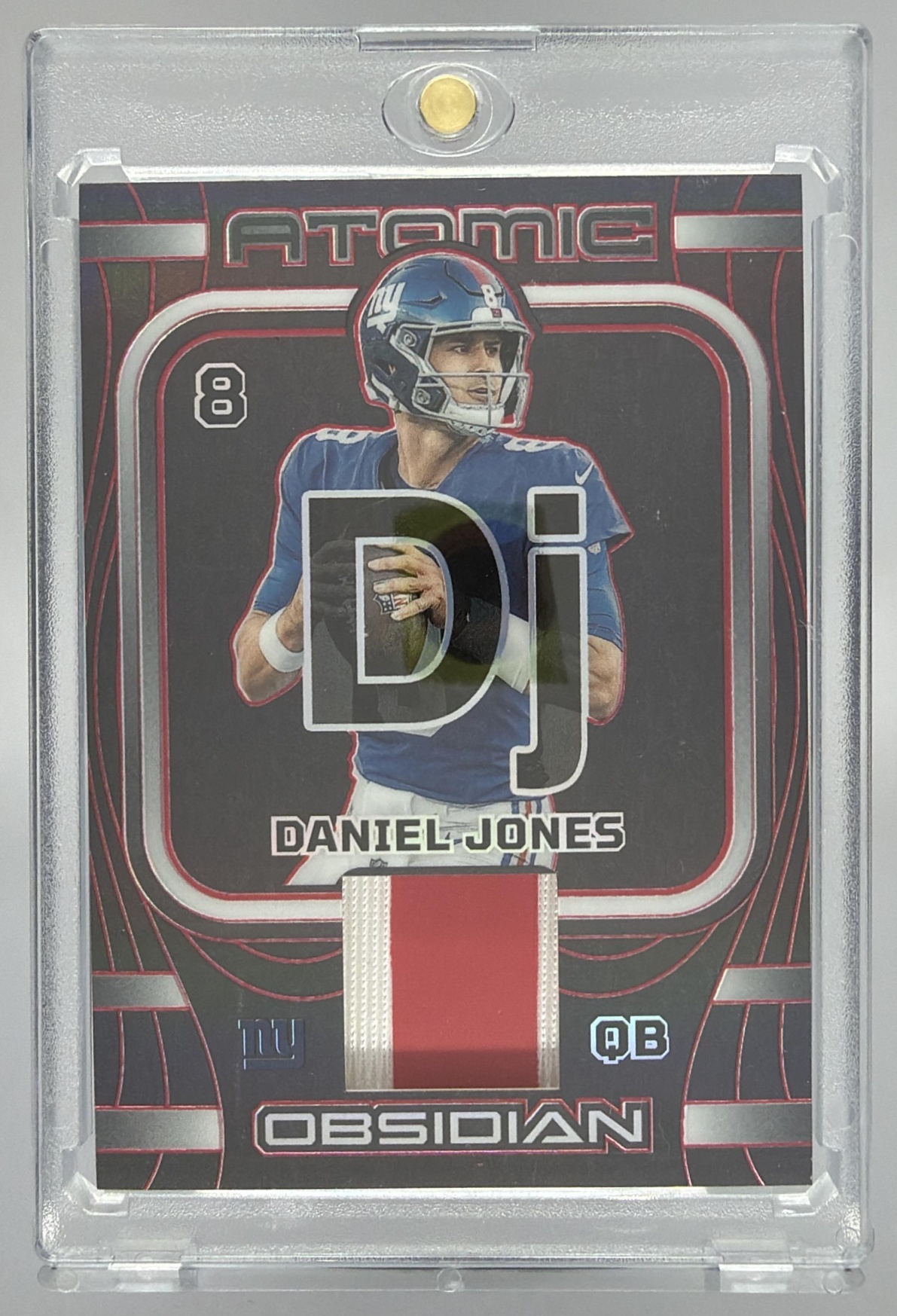 Card image for 2023 Panini Obsidian Daniel Jones Atomic Materials Electric Etch Red /8 #AMA-DJO MEM Giants