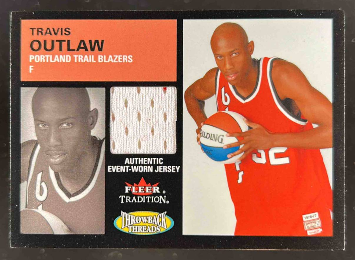 Card image for 2003-04 Fleer Tradition Travis Outlaw Throwback Threads Event Worn #TT-TO RC