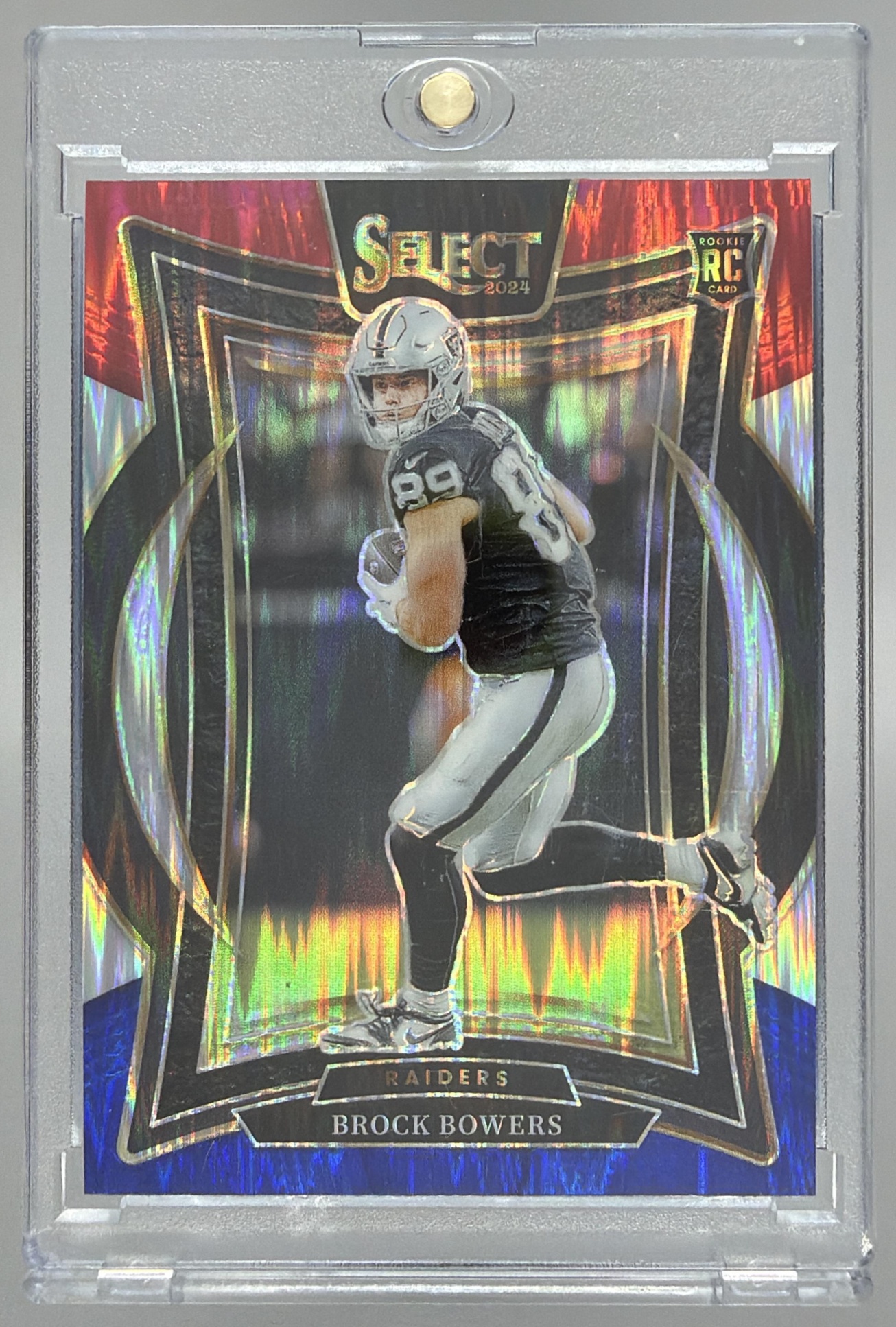 Card image for 2024 Panini Select Brock Bowers Concourse Red and Blue Prizm Shock #31 RC Raiders