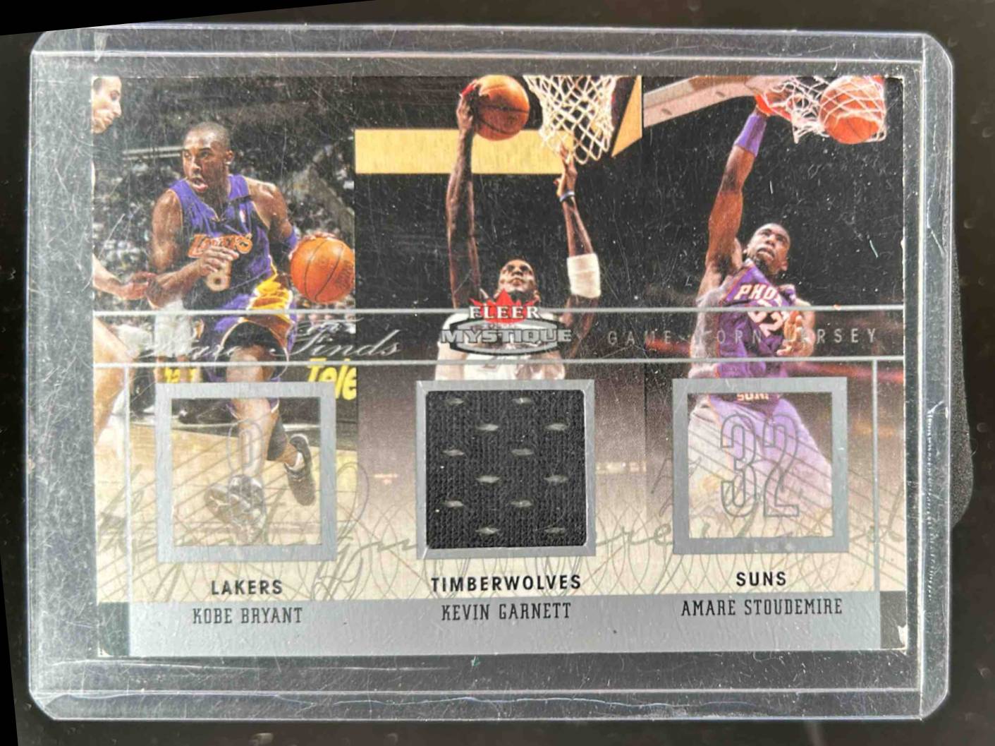 Card image for 2003-04 Fleer Mystique Kobe Bryant / Kevin Garnett Amare Stoudemire Rare Finds Jerseys 224 /300 #RF-KG