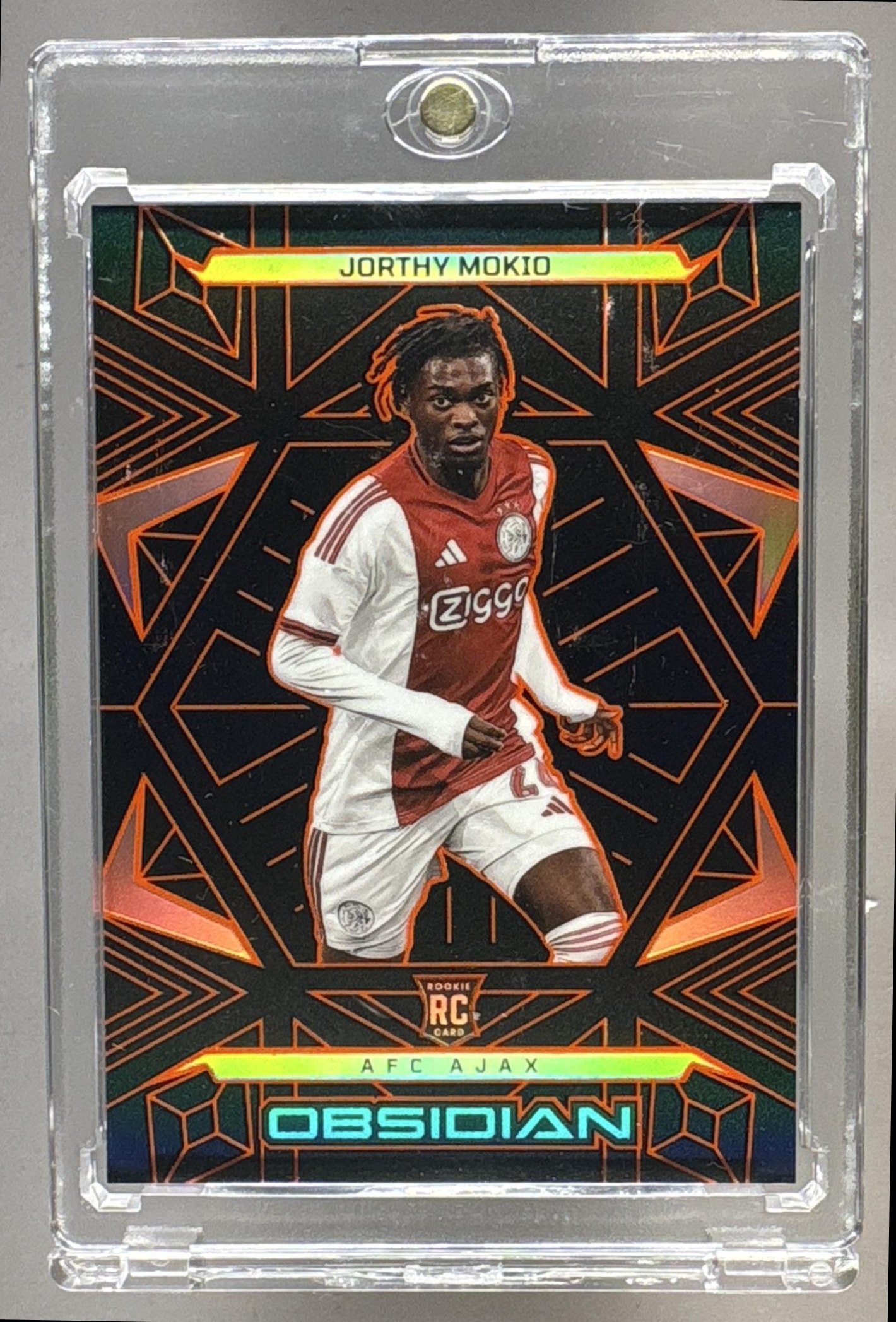 2025-26 PANINI OBSIDIAN JORTHY MOKIO #73 ELECTRIC ETCH ORANGE 38/40 AJAX RC