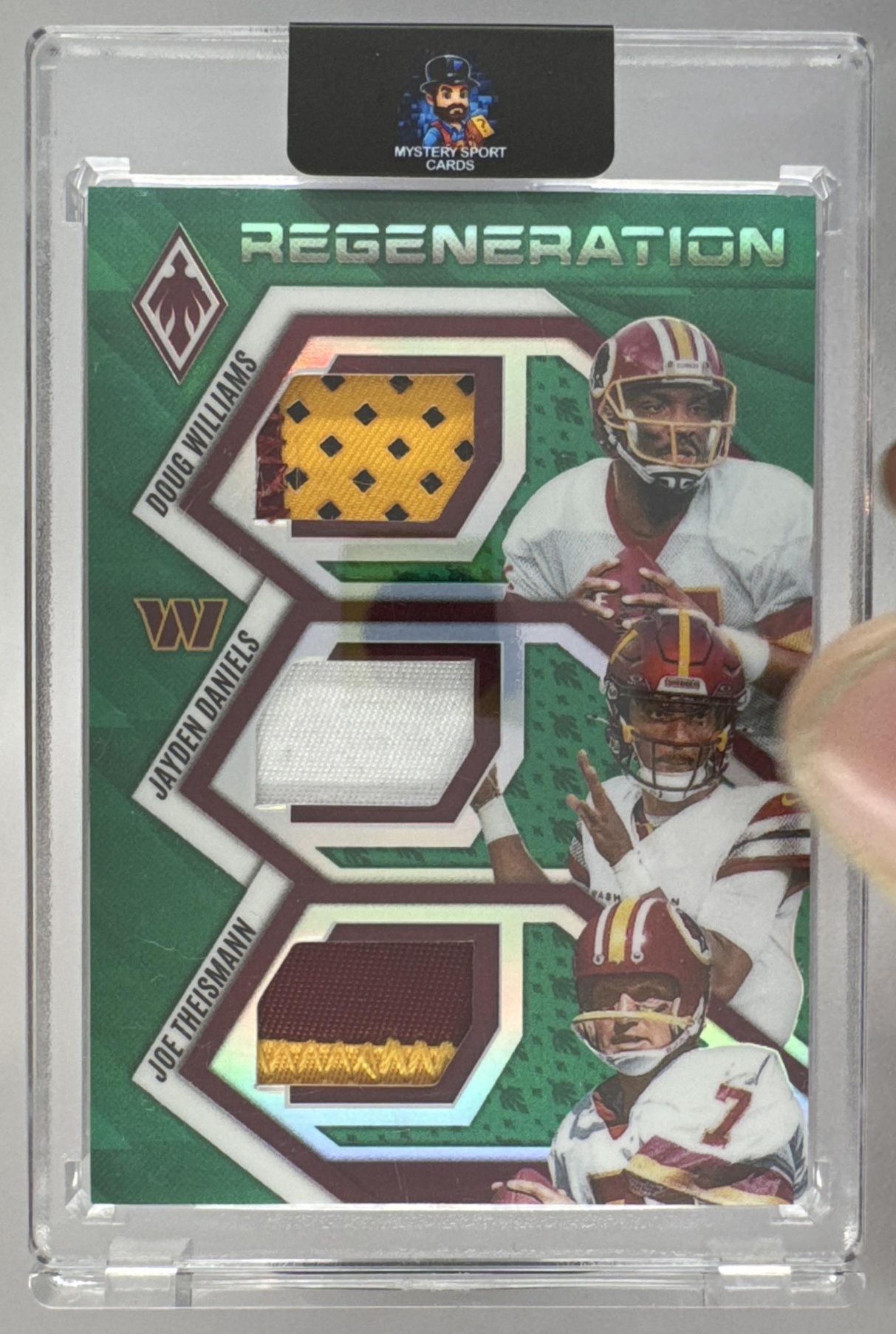 Card image for 2025 Panini Phoenix Doug Williams Jayden Daniels Joe Theismann Regeneration Green Prizm /99 #RGN-WAS MEM