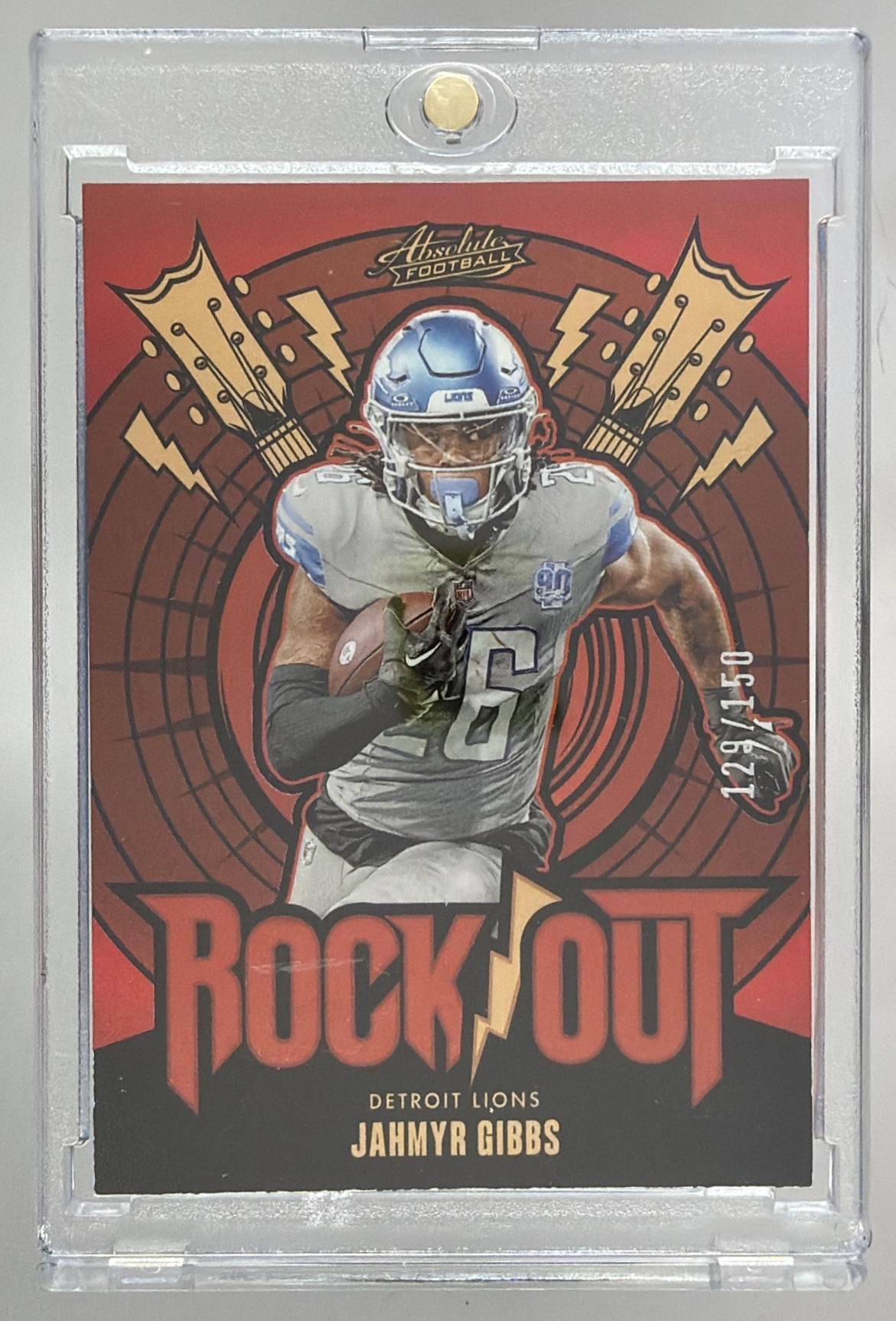 Card image for 2024 Panini Absolute Jahmyr Gibbs Rock Out Red Spectrum /150 #RO-JGS Lions