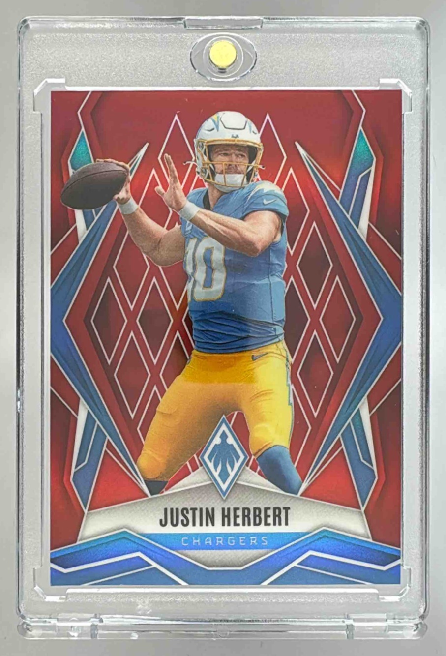 Card image for 2025 Panini Football Phoenix Justin Herbert Red /99 #58 Los Angeles Chargers