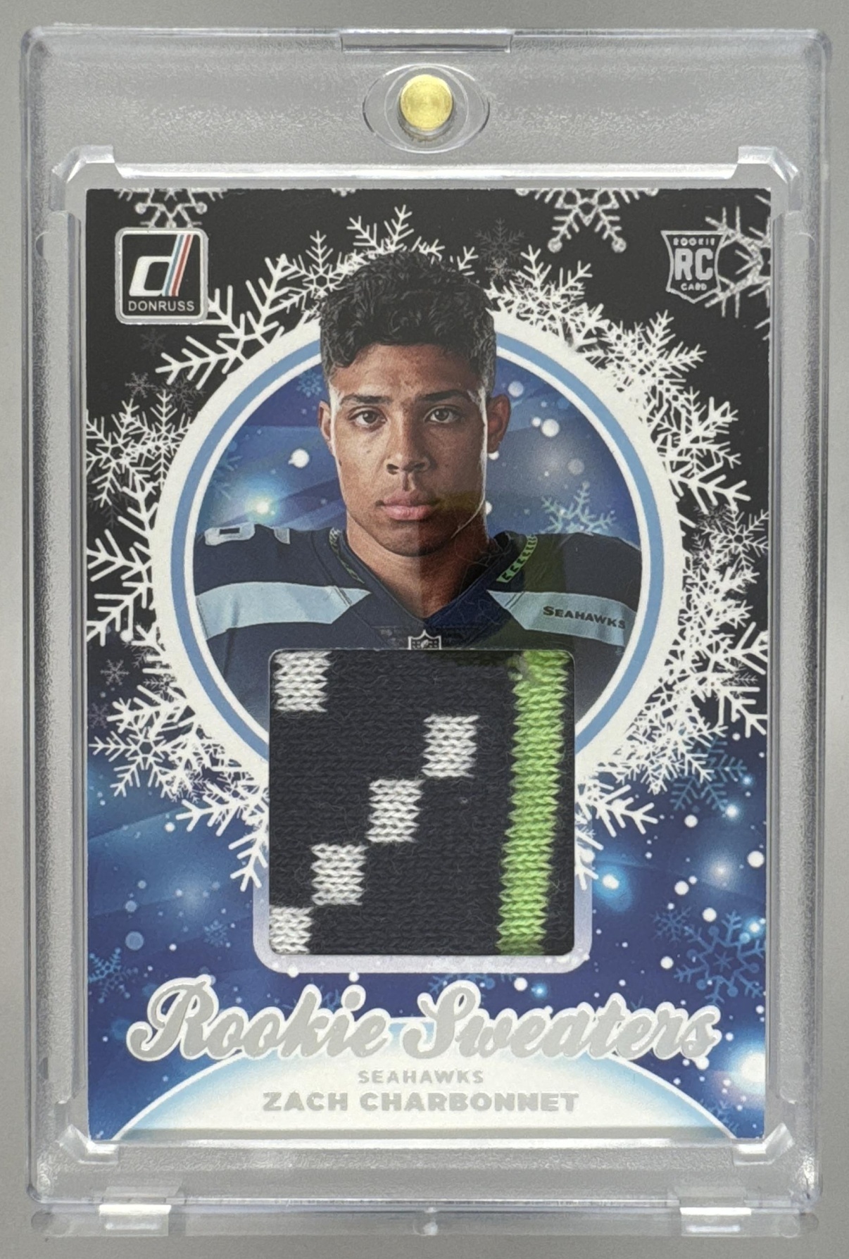 Card image for 2023 Panini Donruss Zach Charbonnet Rookie Holiday Sweater Relics #HS-ZCH MEM RC Seahawks