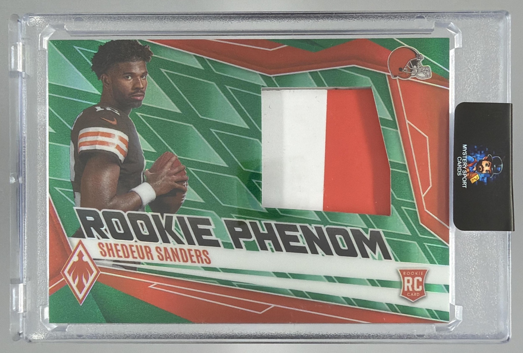 Card image for 2025 Panini Phoenix Shedeur Sanders Rookie Phenom Jersey Green Prizm /99 #PJY-SSS MEM RC Browns