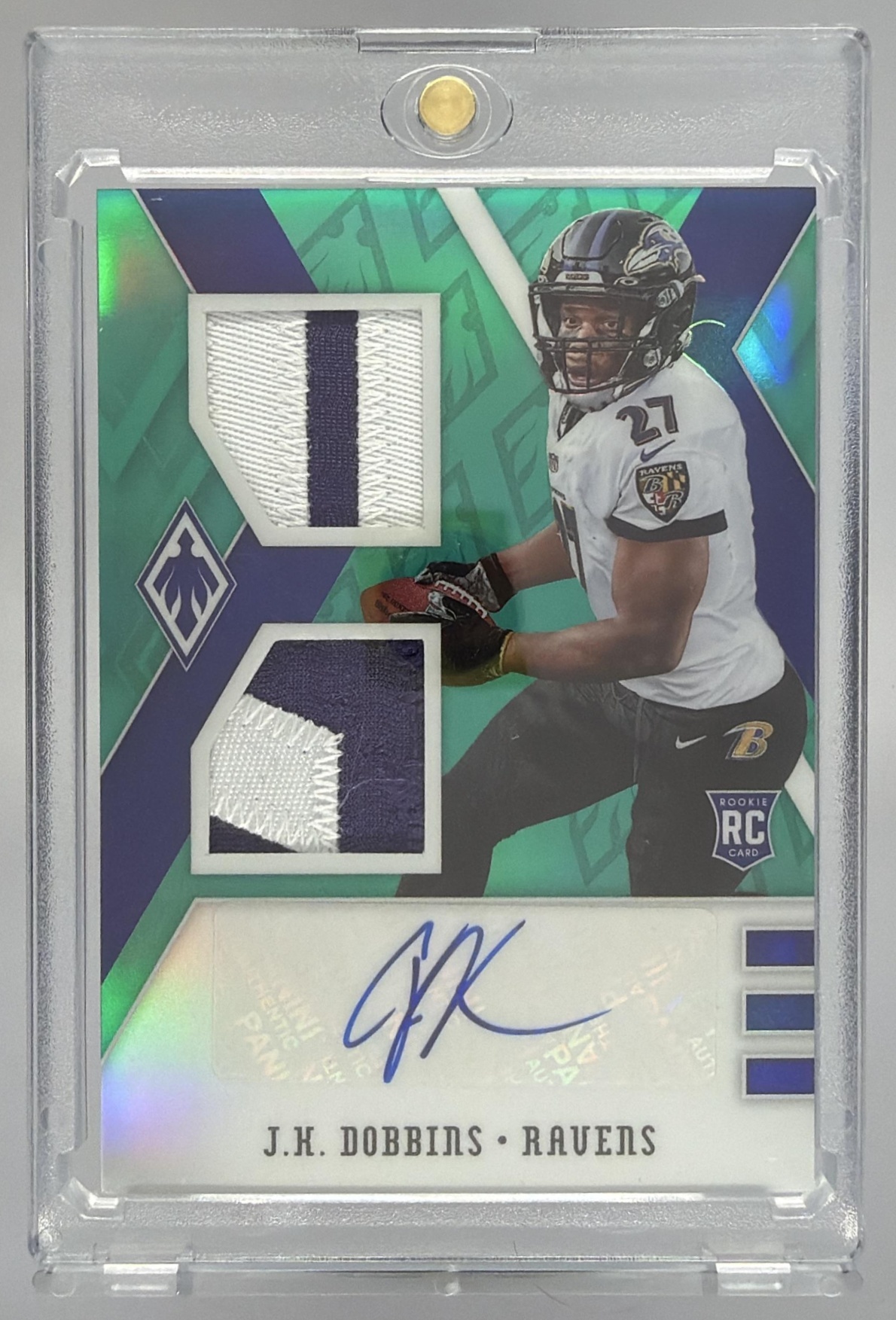 Card image for 2020 Panini Phoenix J.K. Dobbins Rookie Auto Blue /15 #115 RC Ravens