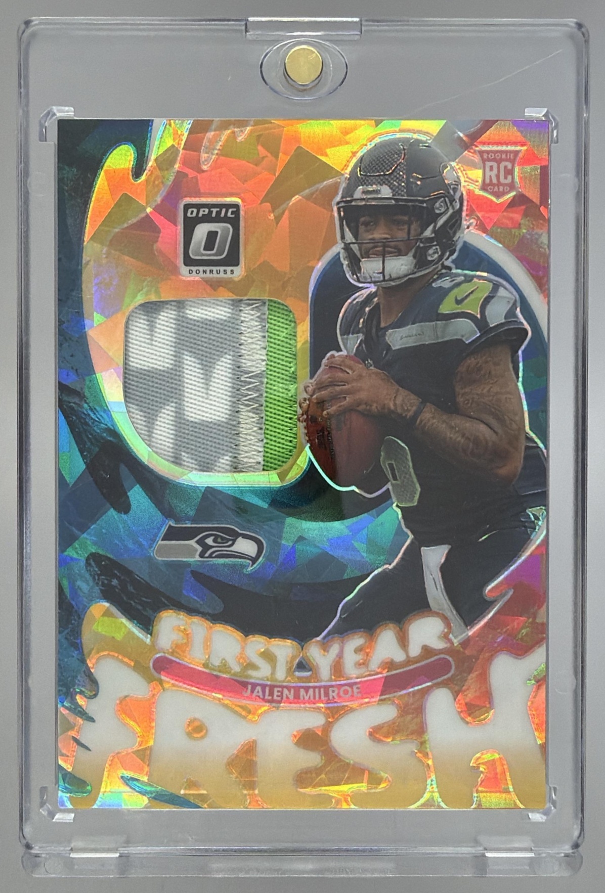 Card image for 2025 Panini Donruss Optic Jalen Milroe First Year Fresh Neon Orange Prizm /49 #FYFBH-JME RC MEM Seahawks