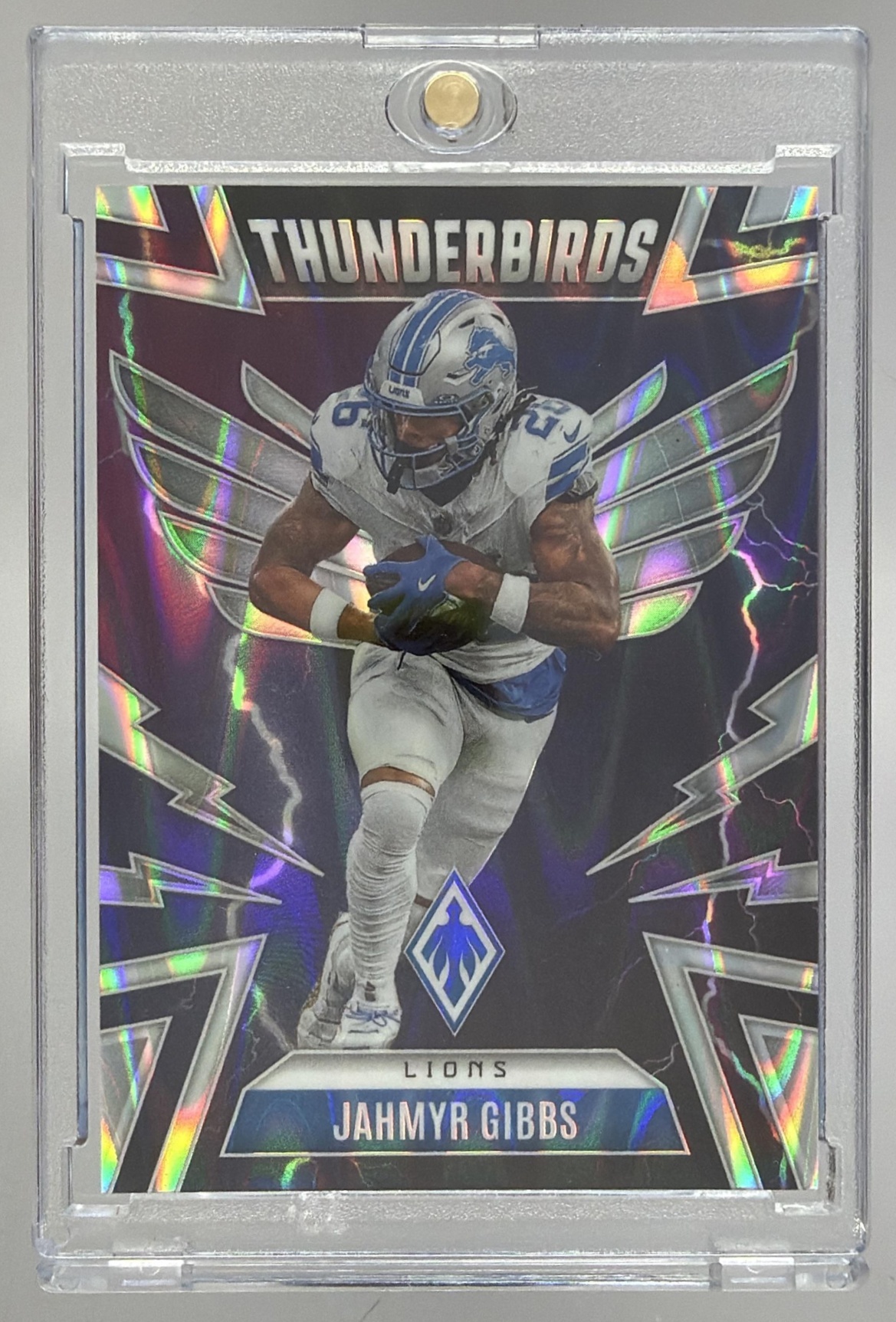 Card image for 2025 Panini Phoenix Jahmyr Gibbs Thunderbirds Silver Seismic Prizm /99 #16 Lions